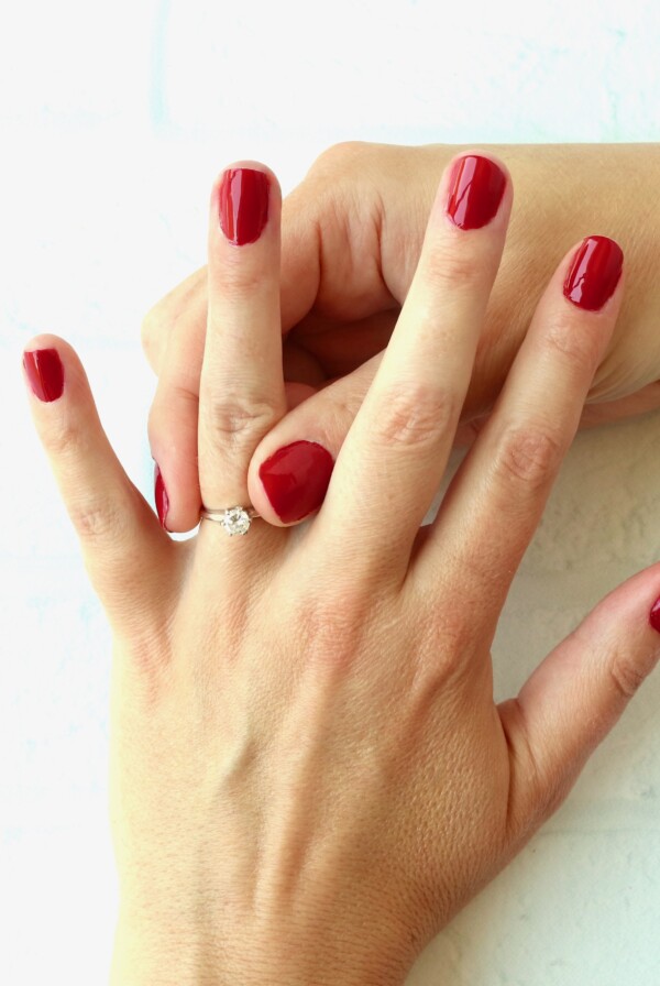 Person taking a ring off of her finger.