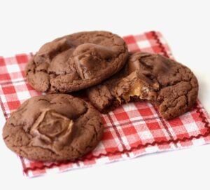 Three Milky Way Cookies on a red and white plaid napkin