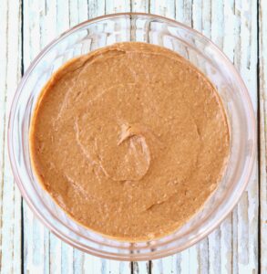 Glass bowl of pumpkin spice cake batter.