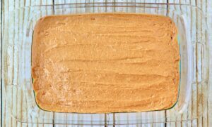 Glass baking dish of pumpkin spice cake batter.