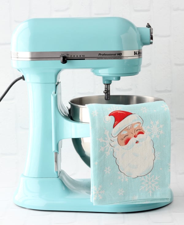 Kitchenaid mixer with tea towel hanging from bowl.
