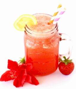 Sparkling Strawberry Lemonade Punch in a jar with a slice of lemon.