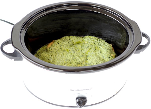 Chicken in crockpot with creamy pesto sauce.