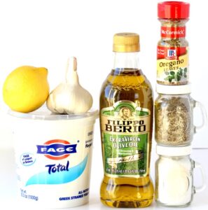 Greek Marinade ingredients including lemon, garlic, and oregano.