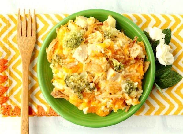 Cooked chicken broccoli casserole in dish with fork.
