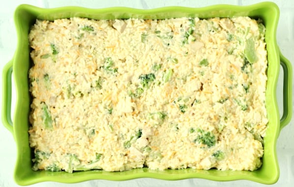 Uncooked chicken broccoli casserole in 9x13 baking dish.