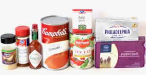 Creamy Tomato Soup ingredients including basil leaves, cream cheese, and Tabasco sauce.