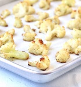 Lined baking sheet of roasted cauliflower.