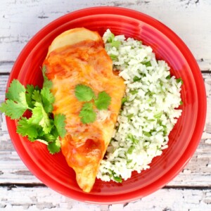 Red plate of Enchilada Chicken.