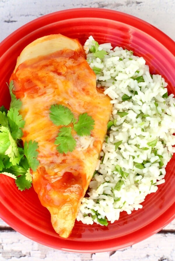 Red plate of Enchilada Chicken.