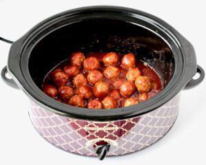 Meatballs and sauce in a slow cooker.
