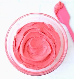 Cherry cookie batter in bowl with spatula.