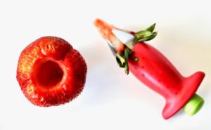Strawberry with the hull removed by a tool.