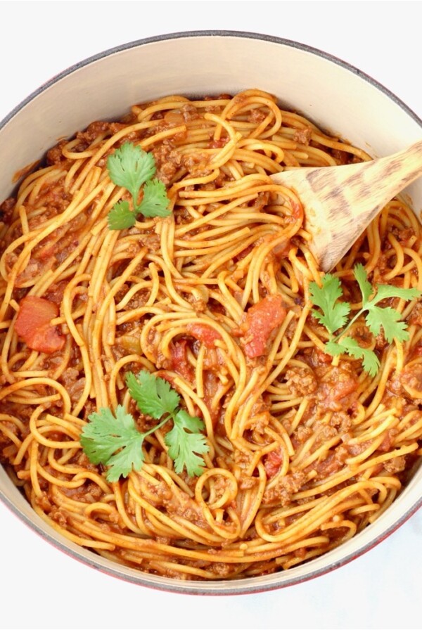 Wooden spoon in a Dutch oven of Taco Spaghetti.