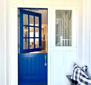 Blue Dutch front door with the top half opened.