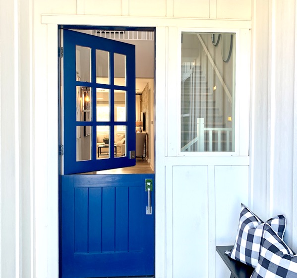 Blue Dutch front door with the top half opened.
