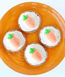 Four Carrot Cake Cookies  on a round, orange plate.