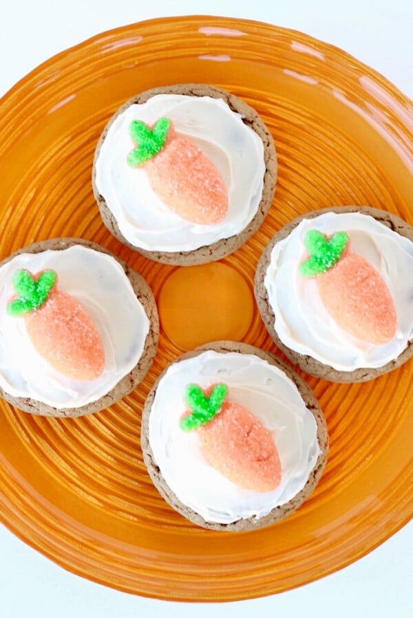 Four Carrot Cake Cookies  on a round, orange plate.