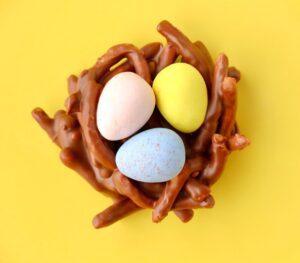 Easter cookie topped with mini eggs colored blue, pink, and yellow.