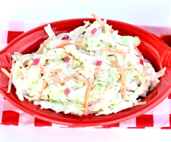 Coleslaw in an oblong red bowl.