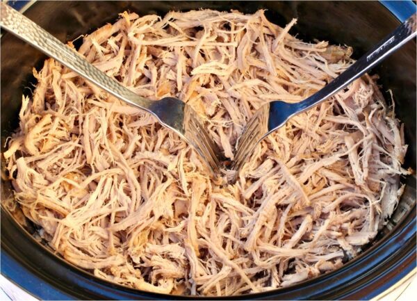 Two forks shredding pork.