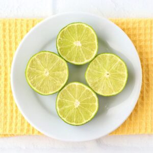 Halved limes on a small plate.