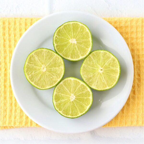 Halved limes on a small plate.