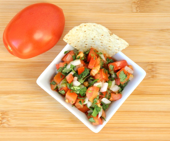 Small bowl of Chipotle Pico de Gallo with a tortilla chip.