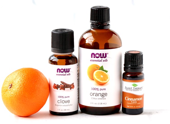 Ingredients for cinnamon spice essential oil diffuser blend including clove, orange, and cinnamon essential oils.