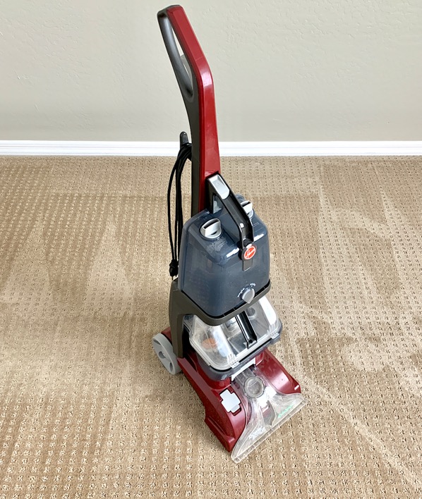 Steam cleaner on clean bedroom carpet.