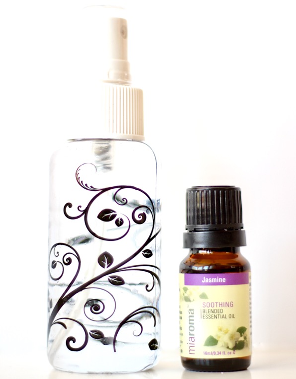Jasmine essential oil spray with bottle of jasmine essential oils to the side.