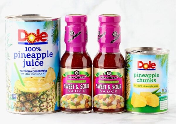 Ingredients for sweet and sour pork including sweet and sour sauce, and pineapple juice and chunks.