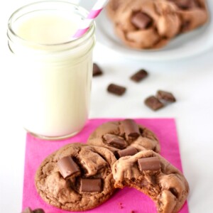 Chocolate Chunk Cookies on a napkin with milk.