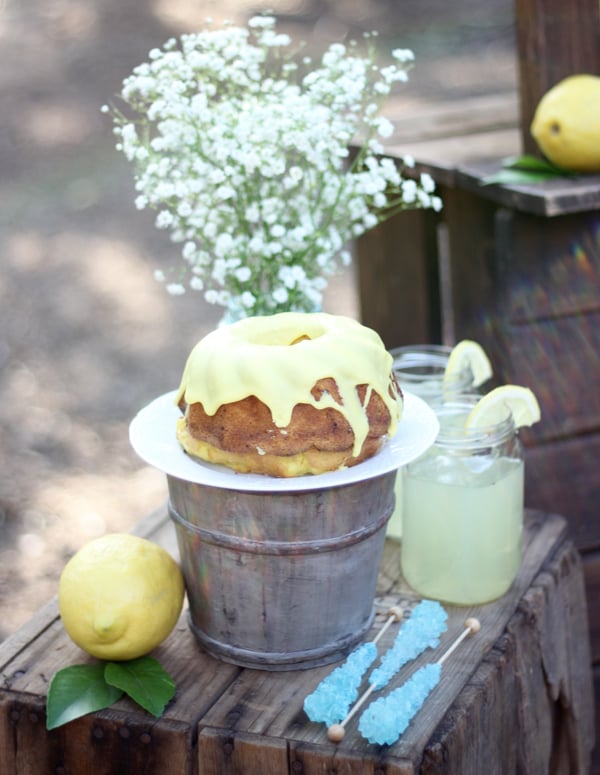 Donut on plate with jar of lemonade to the side.