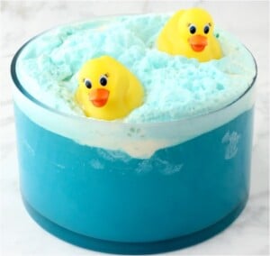 Blue punch in bowl with rubber ducks floating.