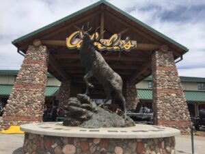 An elk statue standing in front of a Cabela\'s store.
