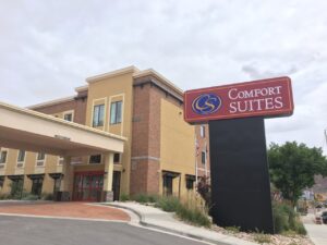 Red Comfort Suites sign in front of a hotel.