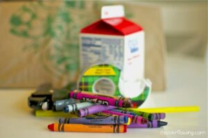 Milk carton, crayons, and tape.