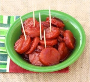 Cooked kielbasa bites in dish with toothpicks.