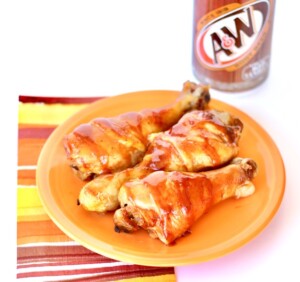 Cooked drumsticks on plate with barbecue sauce.