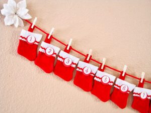 Mini stockings numbered for each day of the month, hanging on red rope.