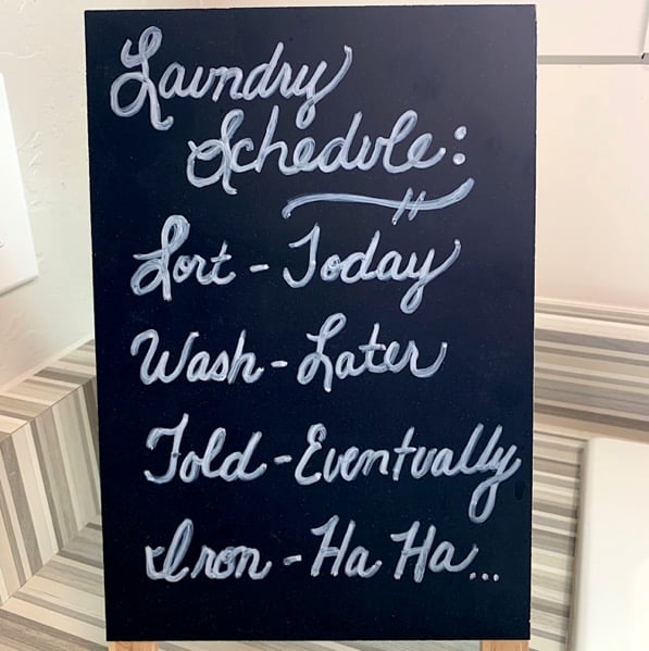 Sign with text \" Laundry Schedule\" Sort - Today Wash - Later Fold - Eventually Iron - Ha Ha...\"