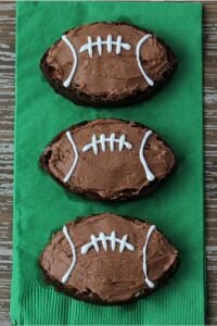 Brownies with chocolate frosting frosted like footballs.
