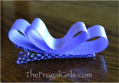 Two loops of lavender ribbon glued to hair clip and pressed down in center.