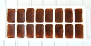 Frozen coffee cubes in ice cube tray.