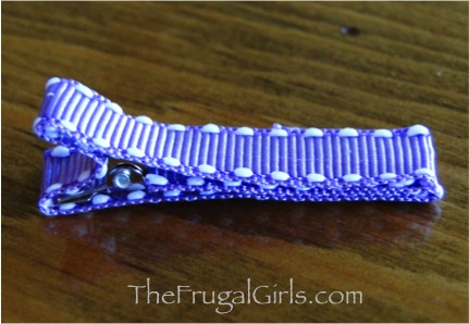 Small hair clip covered in lavender ribbon.