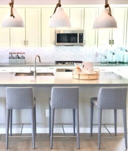 Three chairs set at a kitchen island.