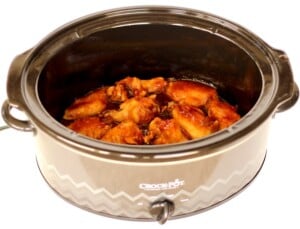Peach chipotle chicken wings in a Crockpot.