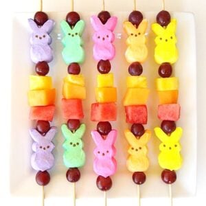 Fruit kabobs on sticks with marshmallow peeps.