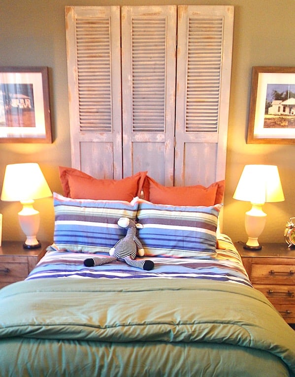 Bed with a headboard made from shutters.